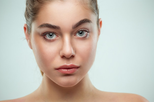 Portrait of a young woman with clear skin and captivating eyes